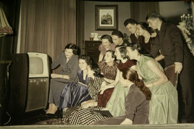 Family in front of a television set, France, ca_ 1950s